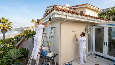 Professional house painters working on coastal home exterior in La Jolla, CA