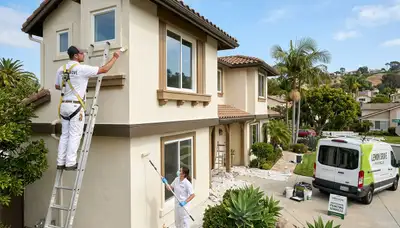 Professional house painters in La Jolla, CA finishing an exterior home painting project