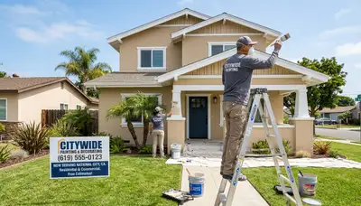 Professional house painters working on coastal home exterior in La Jolla, CA